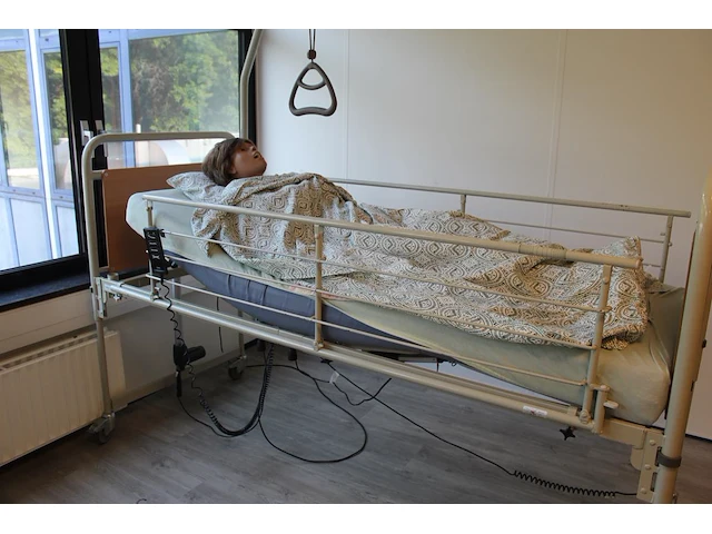 Elektrisch verstelbaar verzorgingsbed met valbeveiliging en bedpapegaai. exclusief pop - afbeelding 3 van  4