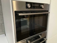 Häcker exclusieve eiland keuken met wand opstelling en kookplaat met afzuiging - afbeelding 38 van  50
