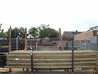 Ruim 70 boompalen in metalen bok. lengte 250 cm. doorsnede 55 mm. let op: exclusief bok. - afbeelding 1 van  3