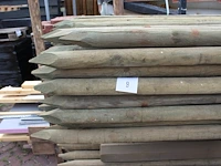 Ruim 70 boompalen in metalen bok. lengte 250 cm. doorsnede 55 mm. let op: exclusief bok. - afbeelding 2 van  3