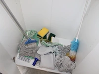 Schoonmaakproducten waaronder theedoeken, schuursponsen en moppen in kast. - afbeelding 1 van  4