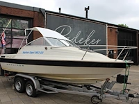 Trailer met speedboot bayliner capri buddy 1952 wit blauw met motor mercruiser 110,4/150,0 pk - afbeelding 7 van  21