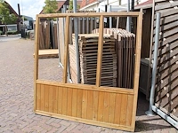 Twee houten terrasafscheidingen met schaamschot en 3 kozijnen per deel. let op: glas ontbreekt - afbeelding 1 van  2