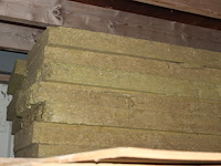 Twee stapels isolatiemateriaal w.o. 90 cm wol met houten afdekking. totaal ca. 70 stuks 60 x 200 cm. - afbeelding 4 van  4