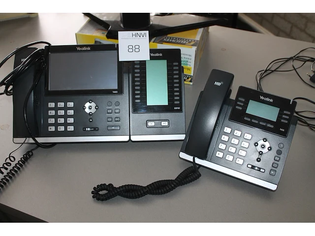 Twee telefoontoestellen yealink waaronder ultra-elegant gigabit ip phone sip-t48g, waarvan een met program... - afbeelding 1 van  1