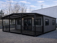 2026 rhino houses 36,5 m2 zwart 2 slaapkamers, badkamer en keuken mobiele woonunit / tiny house met luifel / balkon