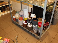 Bloemen en plantenpotten op schap in diverse maten en uitvoeringen. - afbeelding 1 van  2