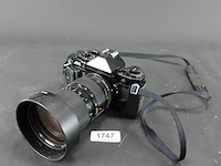 Canon a-1 spiegelreflexcamera uitgerust met een canon new fd 35-105mm f/3.5 zoomlens - afbeelding 1 van  8
