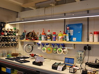 Diverse lakken, lijmen, schoonmaak producten en tapes op schap. - afbeelding 1 van  4