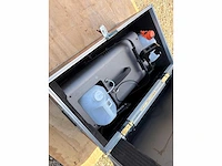 Fog machine with flight case and extra fluid