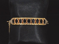 Gouden armband met rode edelstenen