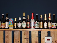 Grote hoeveelheid oude bierflessen en blikken op schap, in drie kast vakken en drie dozen. circa 150 stuks. - afbeelding 10 van  12