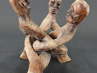 Houten "unity sculpture" met drie figuren die in elkaar verstrengeld zijn, vaak geassocieerd met ghanese houtsnijk - afbeelding 1 van  5