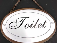 Metalen schild toilet