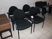 Vier buisstalen stoelen zwart gestoffeerd.