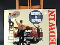 Vintage tinnen reclamebord van het merk edwin met een opvallende rode stationwagen en de tekst "denim is edwin"